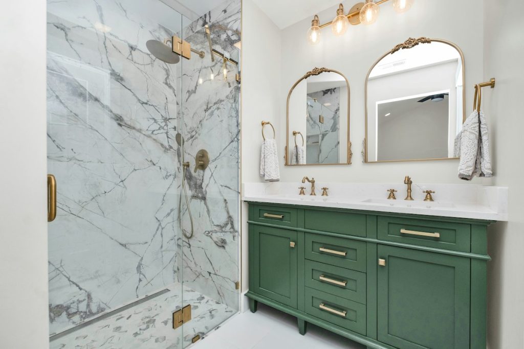 Bathroom with double vanity and marble tiled shower